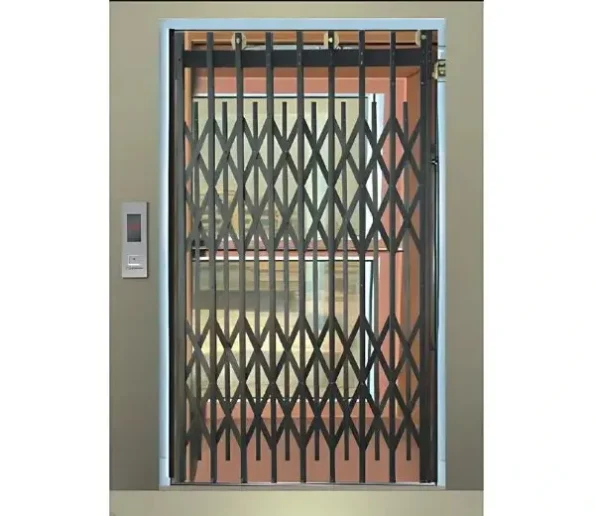 Passenger Manual elevator with a closed, black manual collapsible gate door and a silver call button panel on the wall.