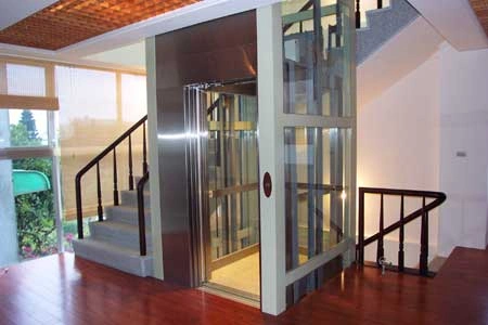 Hydraulic home lift installed in a modern duplex house, providing easy access between floors.